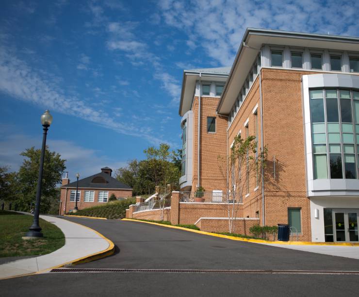 Red brick building set on road heading uphill