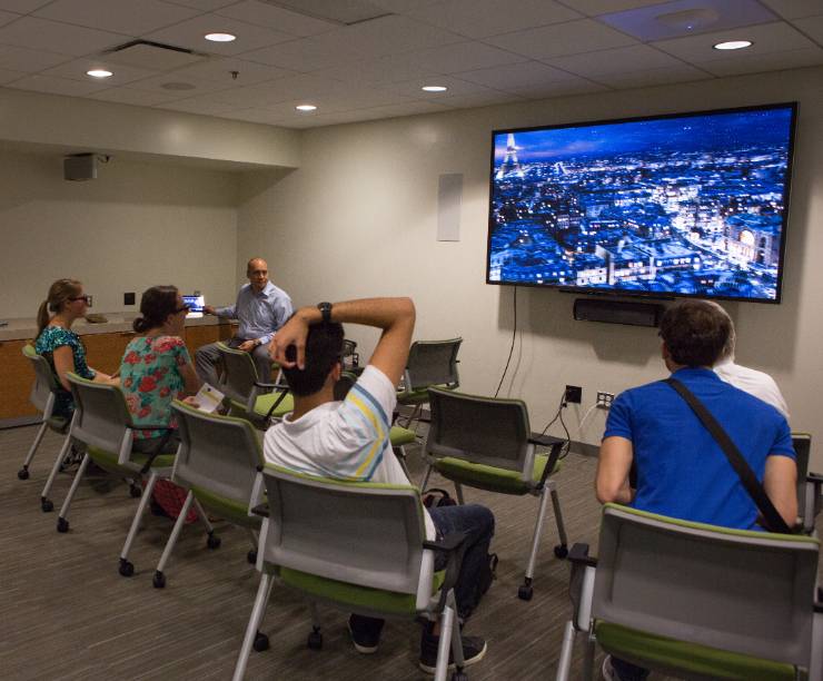 Students in 3D glasses view a screen.