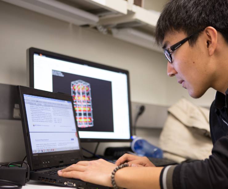 A student works at a computer.