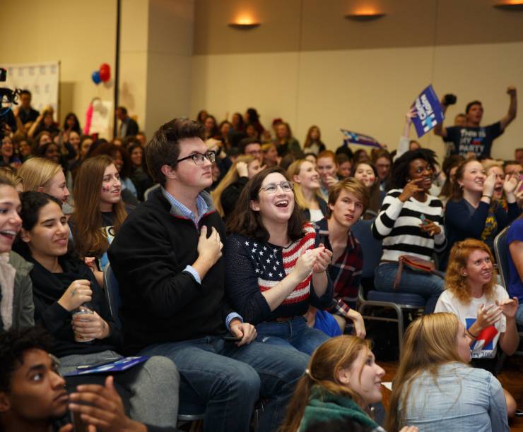 A crowd of excited students pack a room.