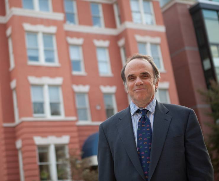 Dean Feuer stands in front of the GSEHD building.