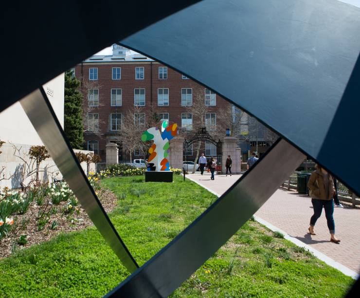 One sculpture is viewed through another along the Mid-Campus Quad walkway.