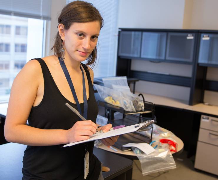 A student stands in an office.