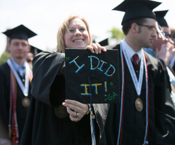 Student shows mortar board with 