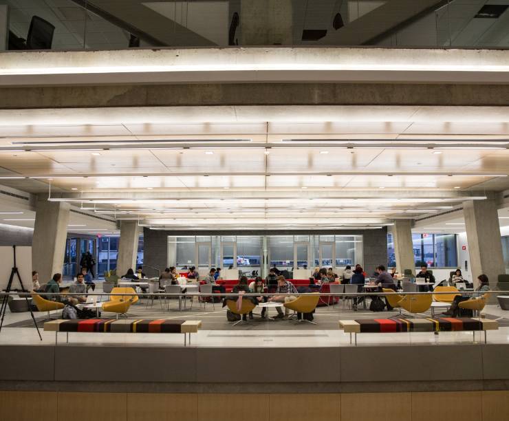 A view of students enjoying an open lounge area.