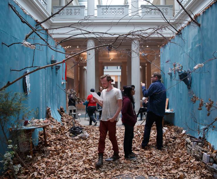 Visitors walk through an arts installation.