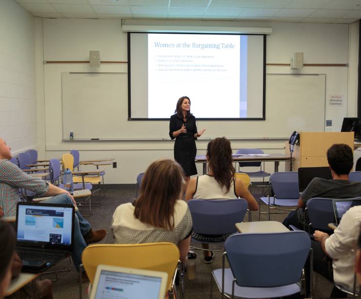 Dr. Lara Brown teaching a classroom full of students.