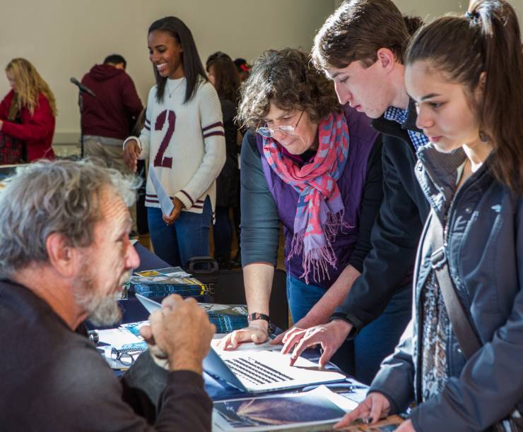 College representatives review artwork and offer critique to high school students.