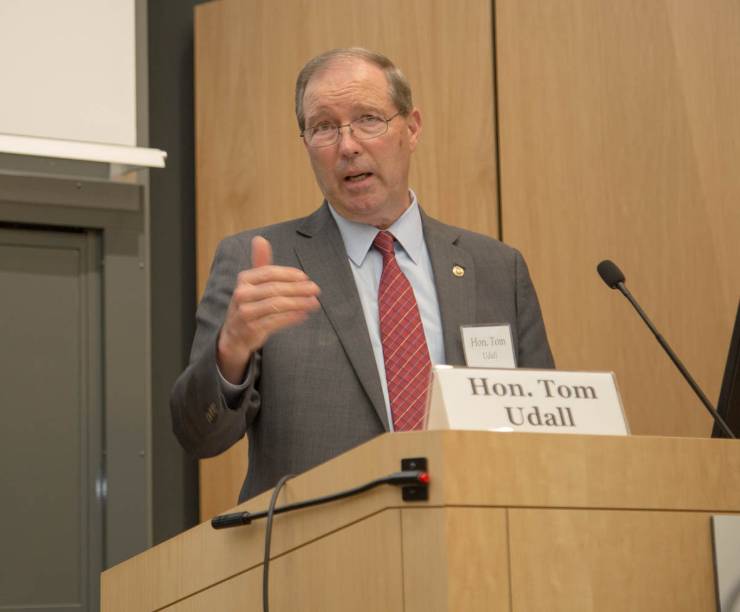 Sen. Tom Udall speaks from behind a podium.