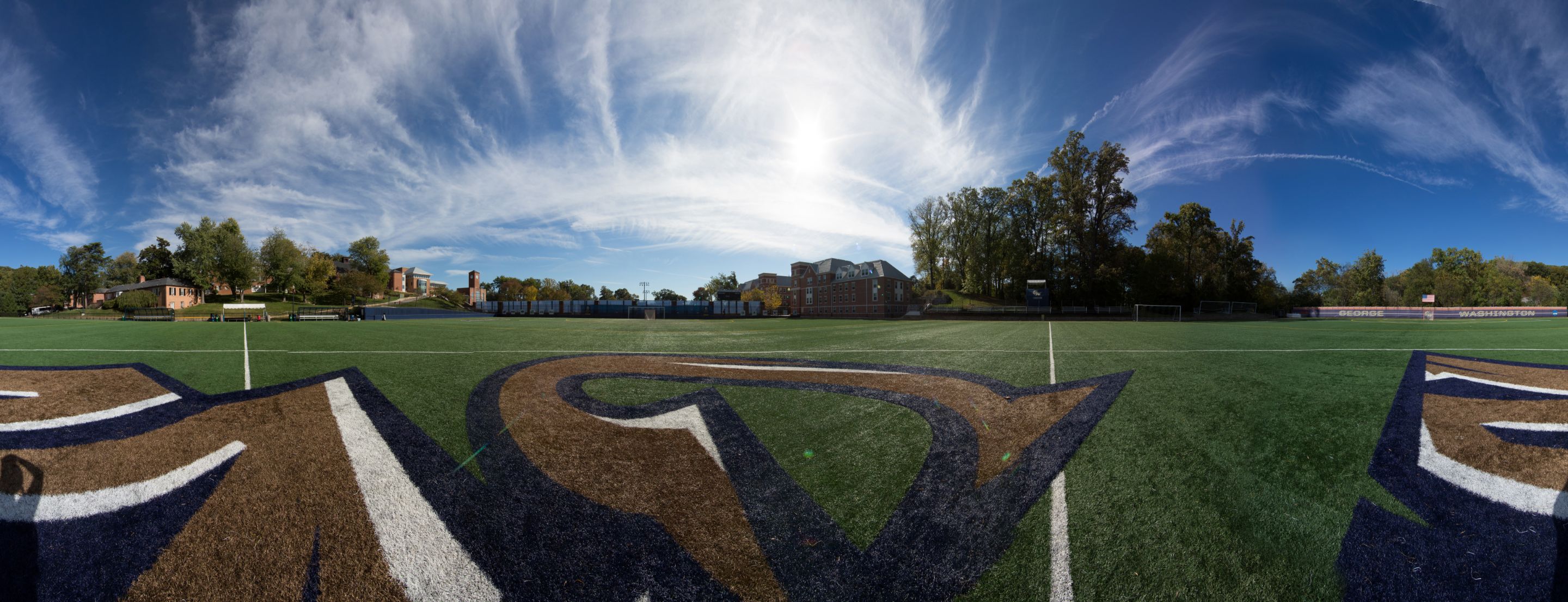 A panoramic view of the Athletic Field and a blue, sunny sky.