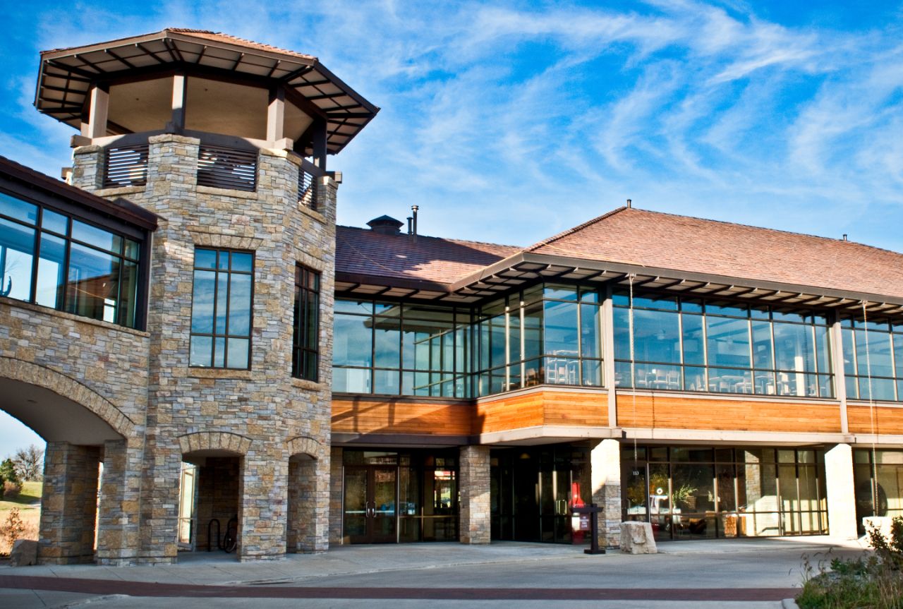 A view of the Agora Center from the sidewalk below, showing one tower and the glass windows of the second floor.