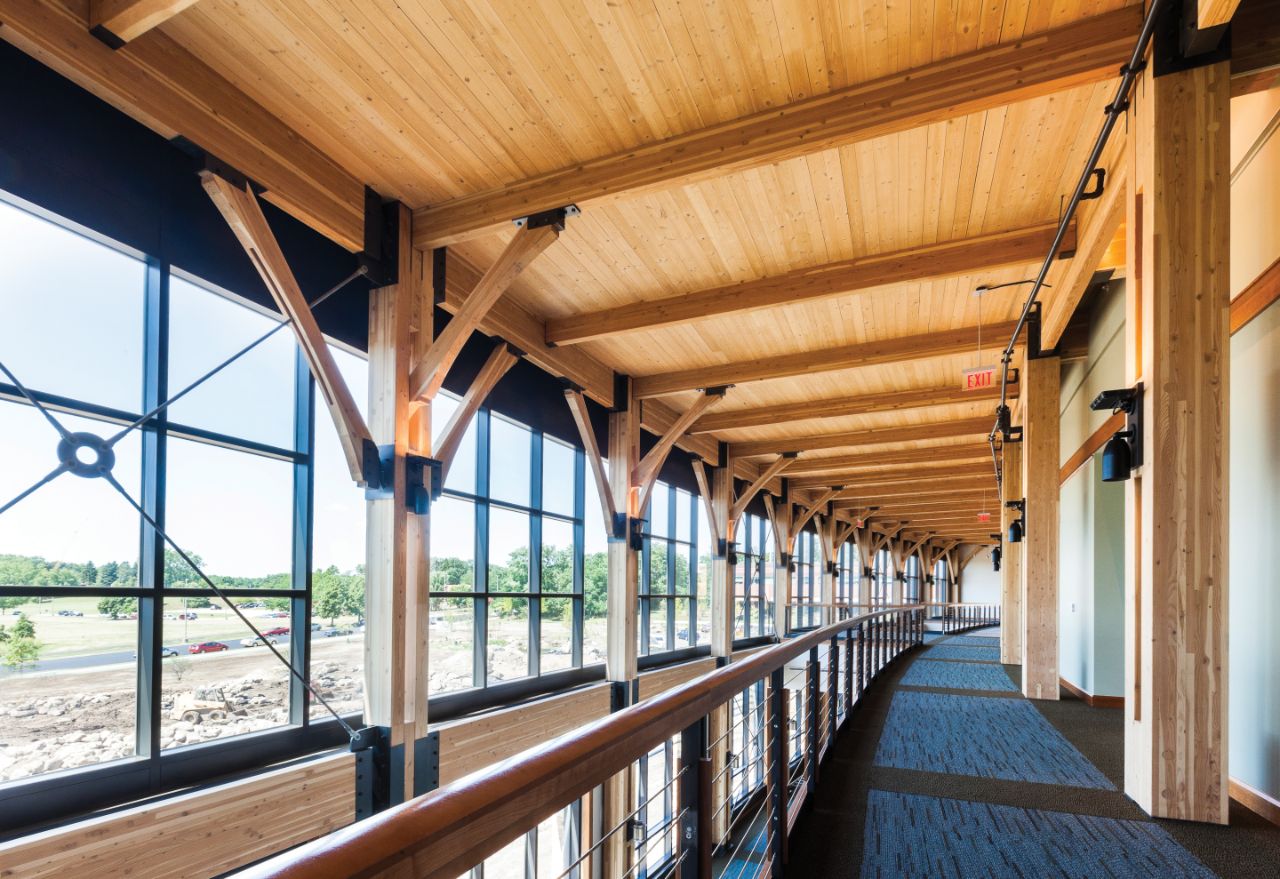 The second floor hall of Feynman with wooden beams and floor to ceiling windows.