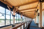 The second floor hall of Feynman with wooden beams and floor to ceiling windows.