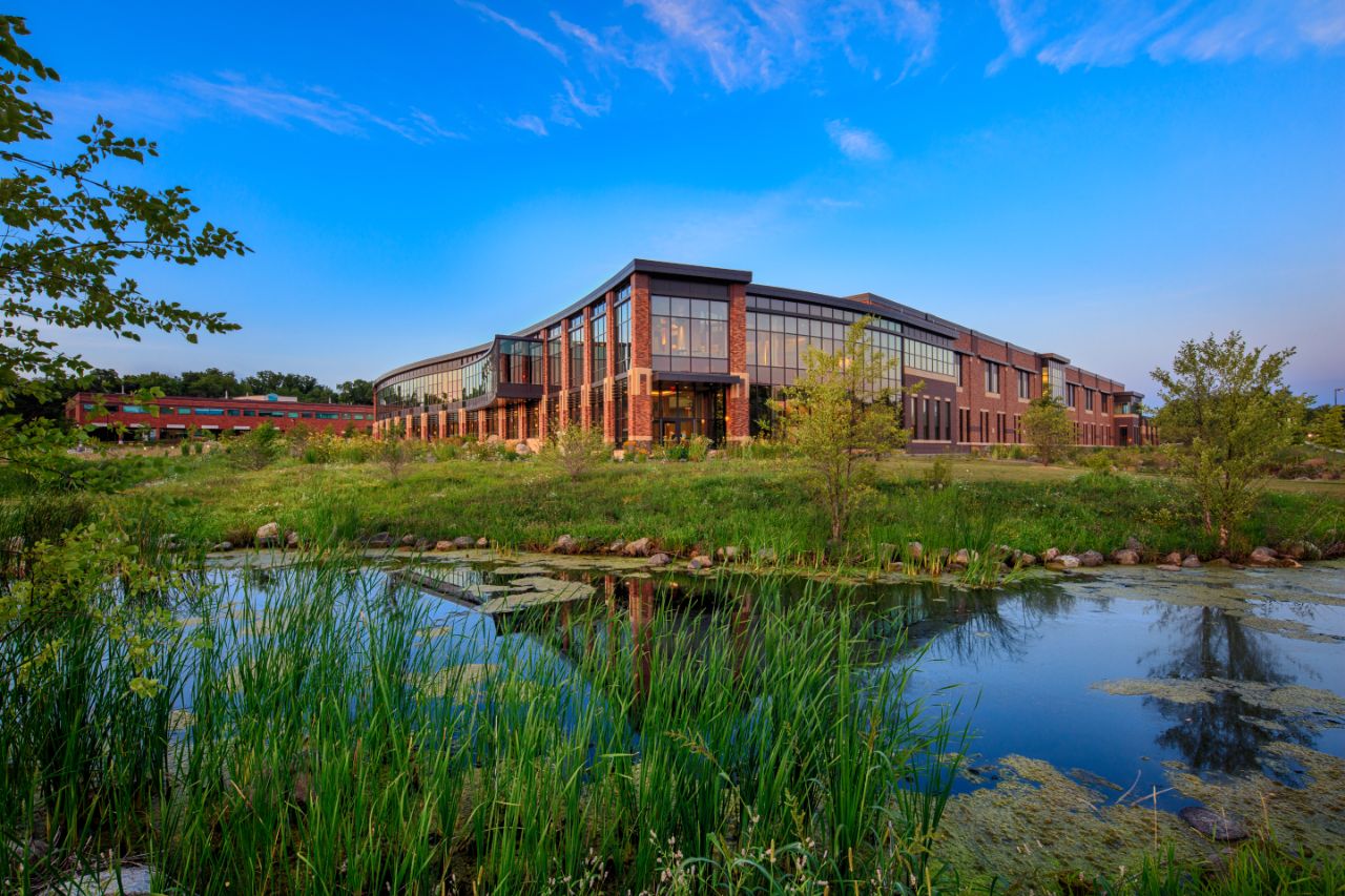 View of the Feynman Center's floor to second story ceiling glass windows from the small pond out front.