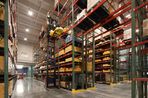 This is a picture of the Kepler Center loading docks, featuring conveyer belts, shelving and forklifts.