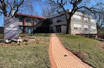 The Faraday Center sign next to the driveway.