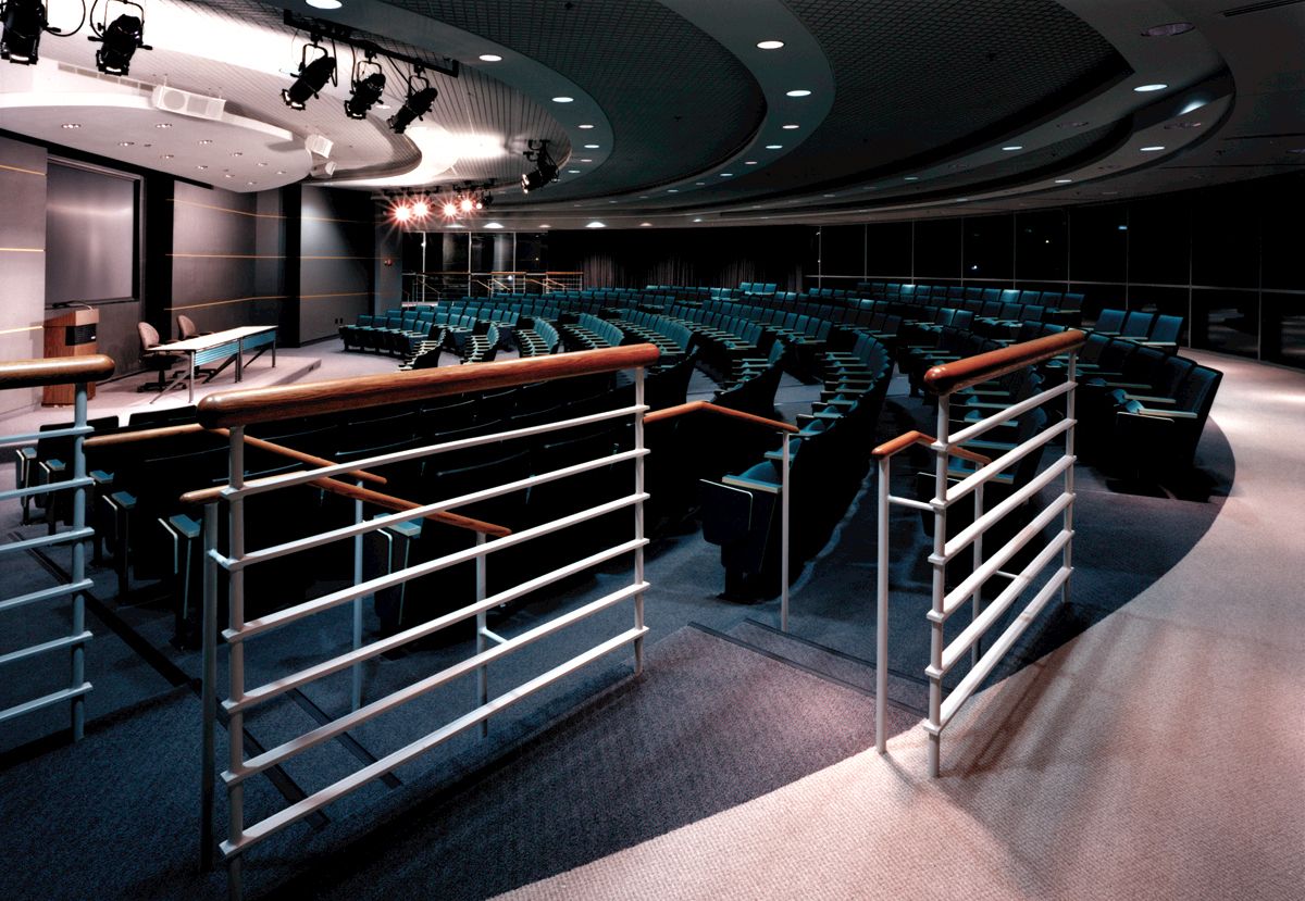 The BTC auditorium contains a podium with projection and lighting as well as dark blue/green seats for up to 300 people.