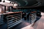 The BTC auditorium contains a podium with projection and lighting as well as dark blue/green seats for up to 300 people.