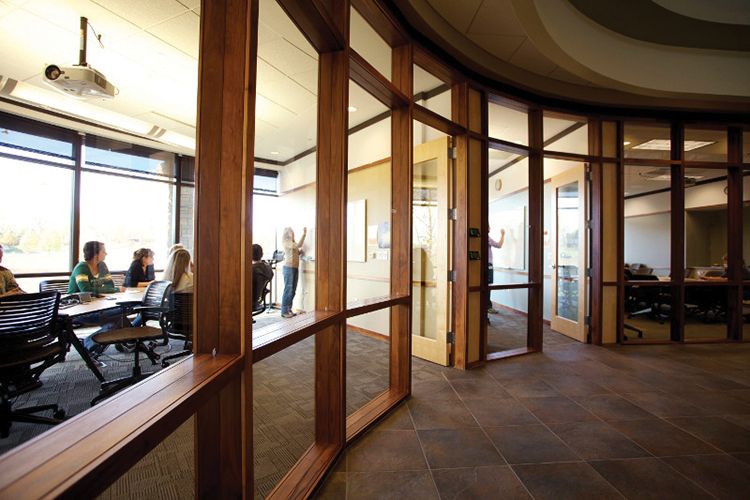 This picture shows a meeting room in Agora which is in use and has floor to ceiling glass windows.