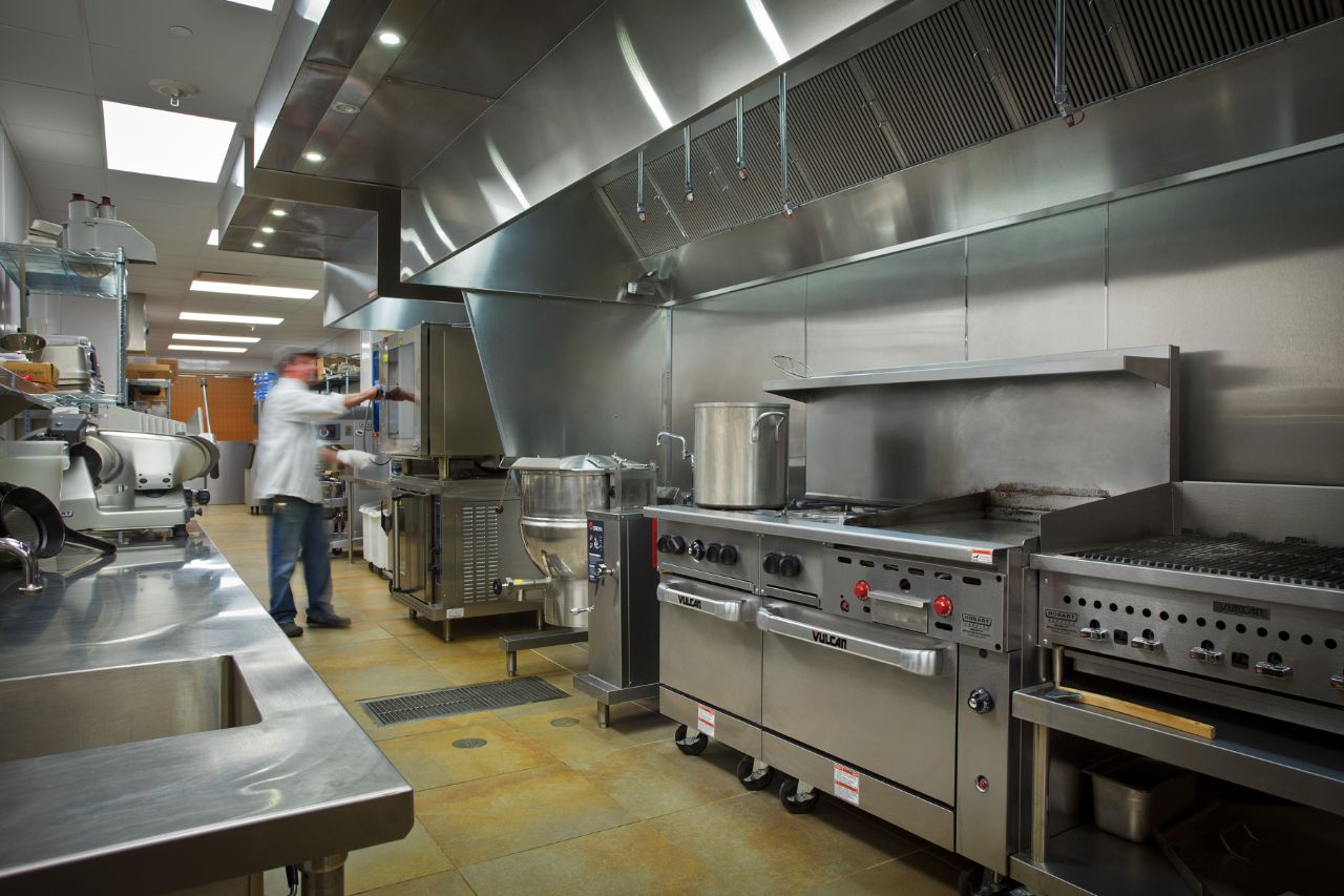 The Feynman cafeteria is pictured here with one of our chefs baking with a large industrial oven.