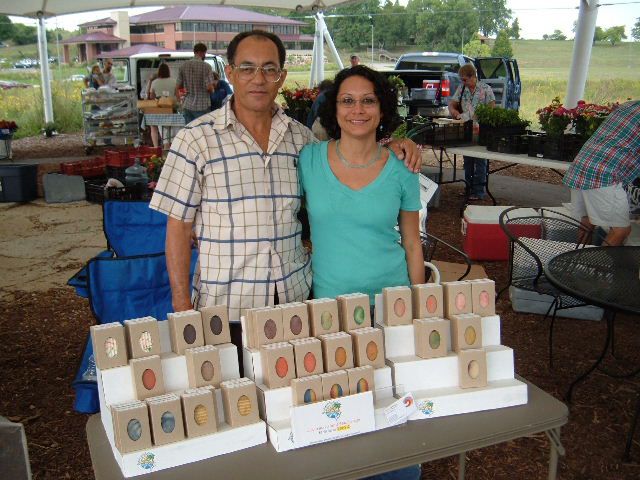 Two vendors pose for a picture at the farmer's market.