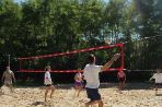 A picture of the volleyball players in a match on the volleyball courts.