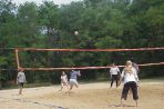 Volleyball players wait for a ball to drop