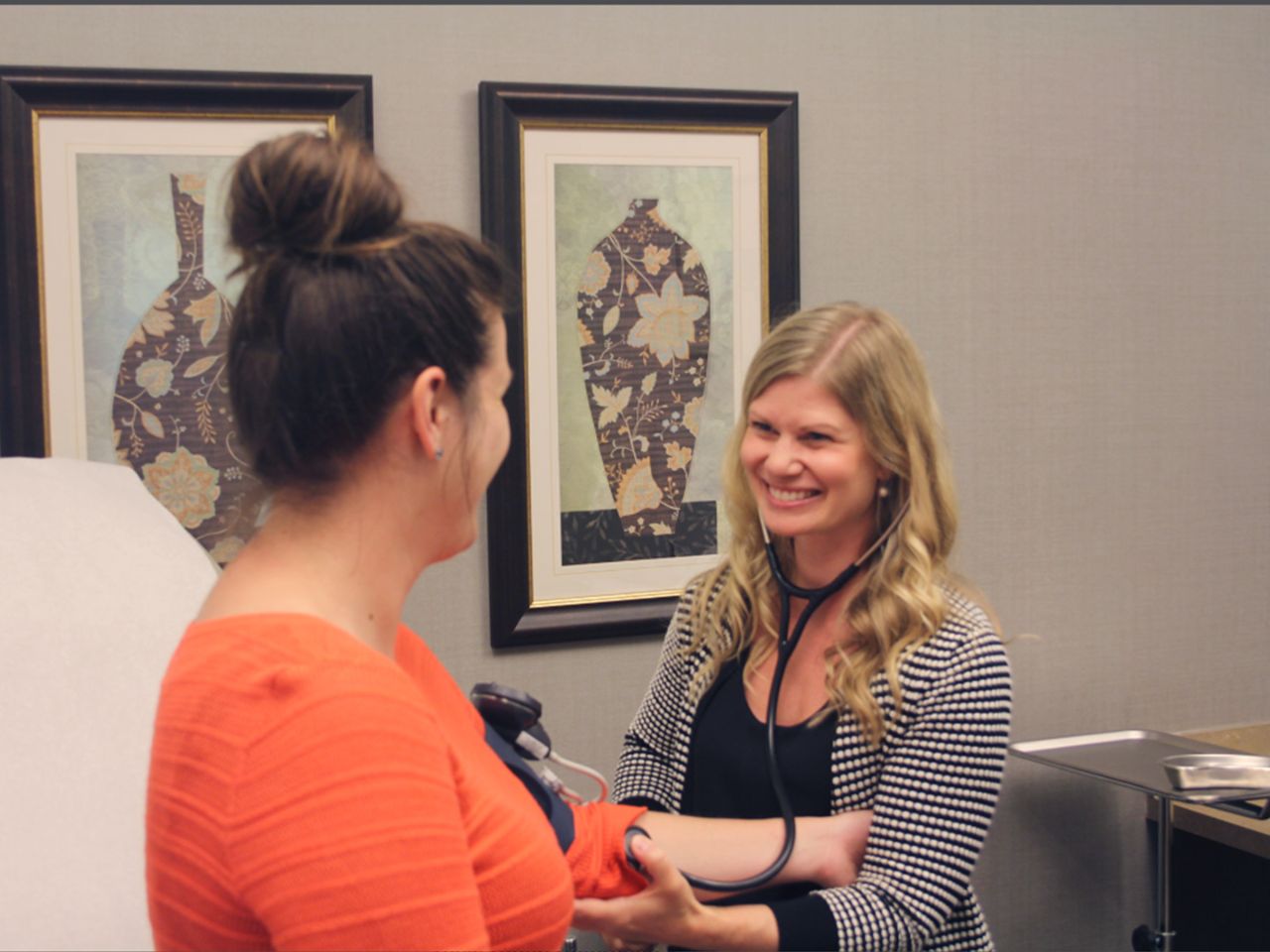 A picure of the Promega nurse practitioner taking a patient's blood pressure.