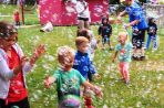 Children at Woods Hollow Children's Center play and dance in a sea of bubbles.