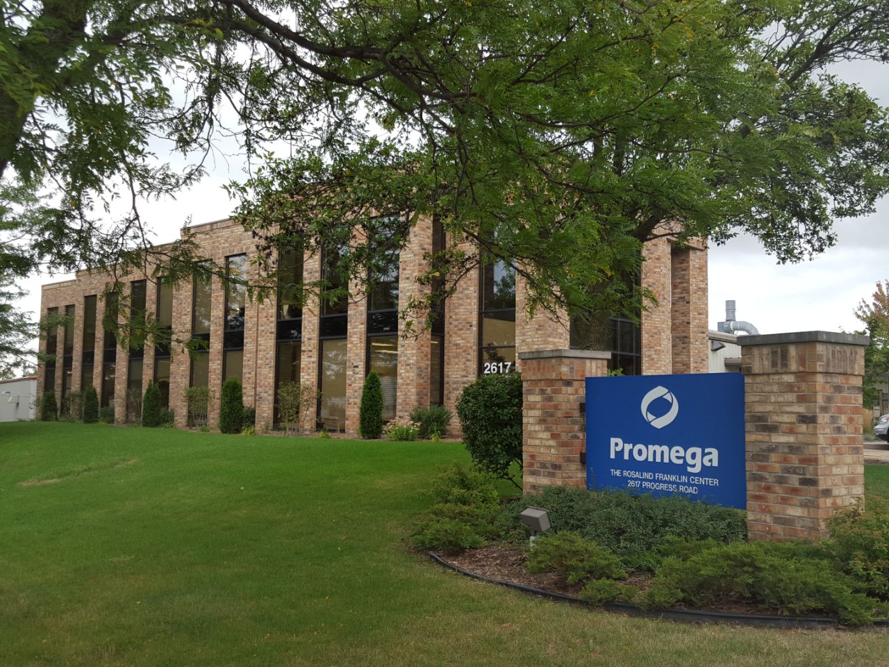 The Rosalind Franklin Center from the view of the driveway with the Promega sign out front.