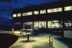 The ground lights of the RDC light up the exterior of the building at night.