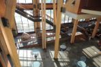 The Feynman Center from the second floor balcony showing the two story wooden support beams.