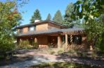 View of the front of the guest house with fall foliage.