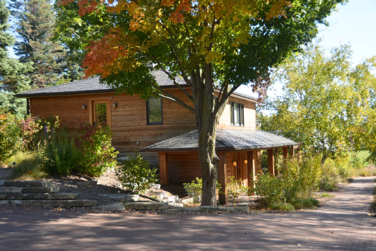 View of the guest house from the parking lot with fall foliage around.