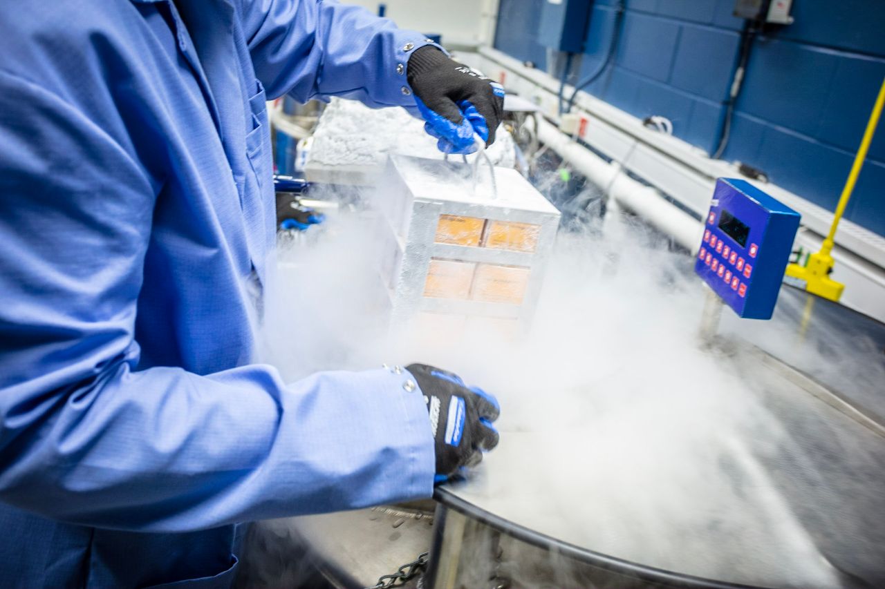 A packaging expert lifts a stack of packages out of the cryo tanks in the Kepler building.