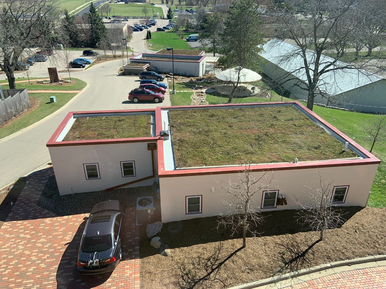 The rooftop of the upper lab includes a garden of grass and shrubs.