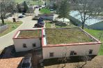 The rooftop of the upper lab includes a garden of grass and shrubs.