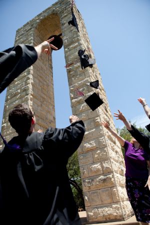 Graduates toss their caps