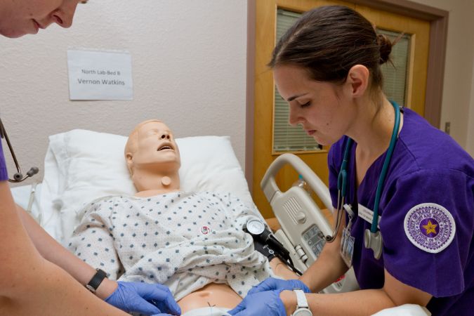 Students work with simulated patient