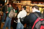 Four male students standing in line at Starbucks for coffee.