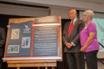 Adam W. and Karen Herbert stand with a dedication plaque for the Adam W. Herbert University Center.