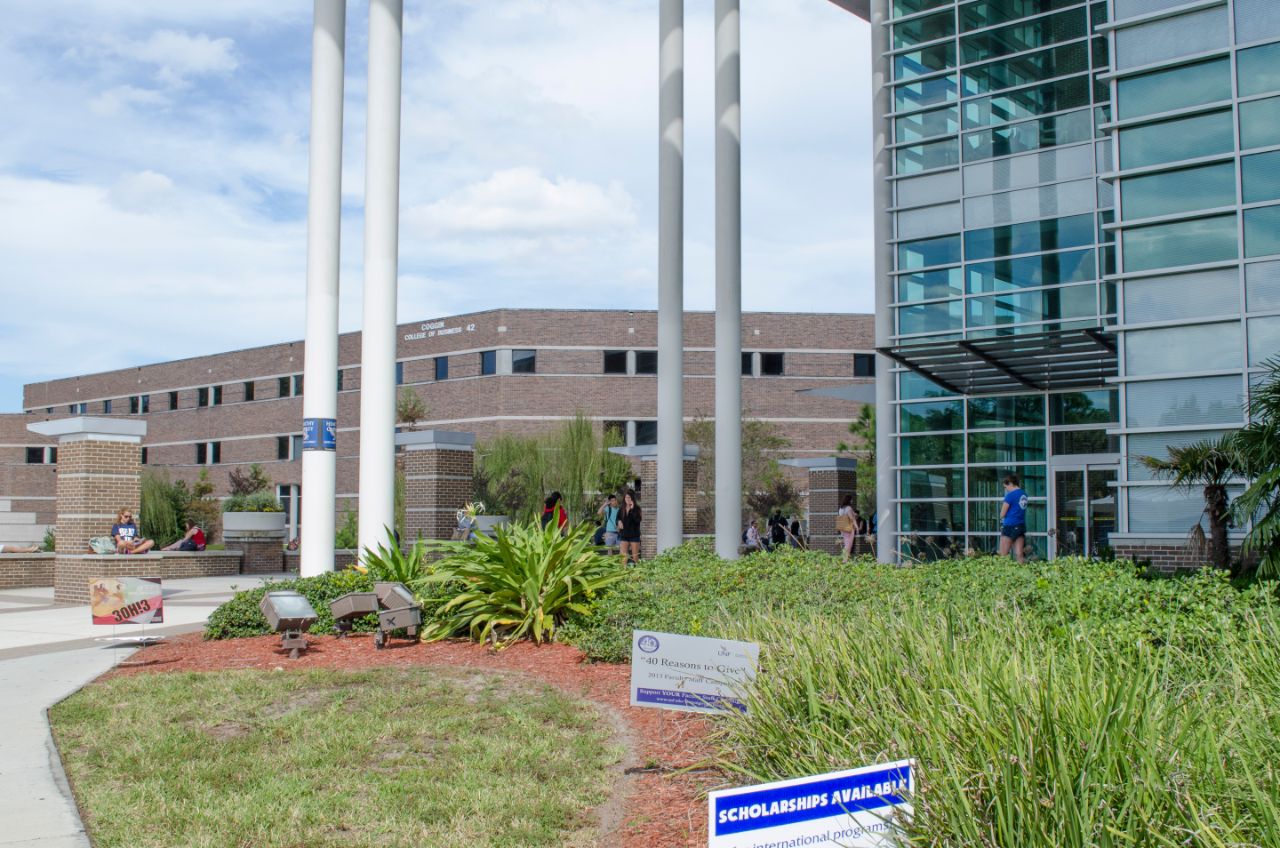 A group of students outside the Library walking by.