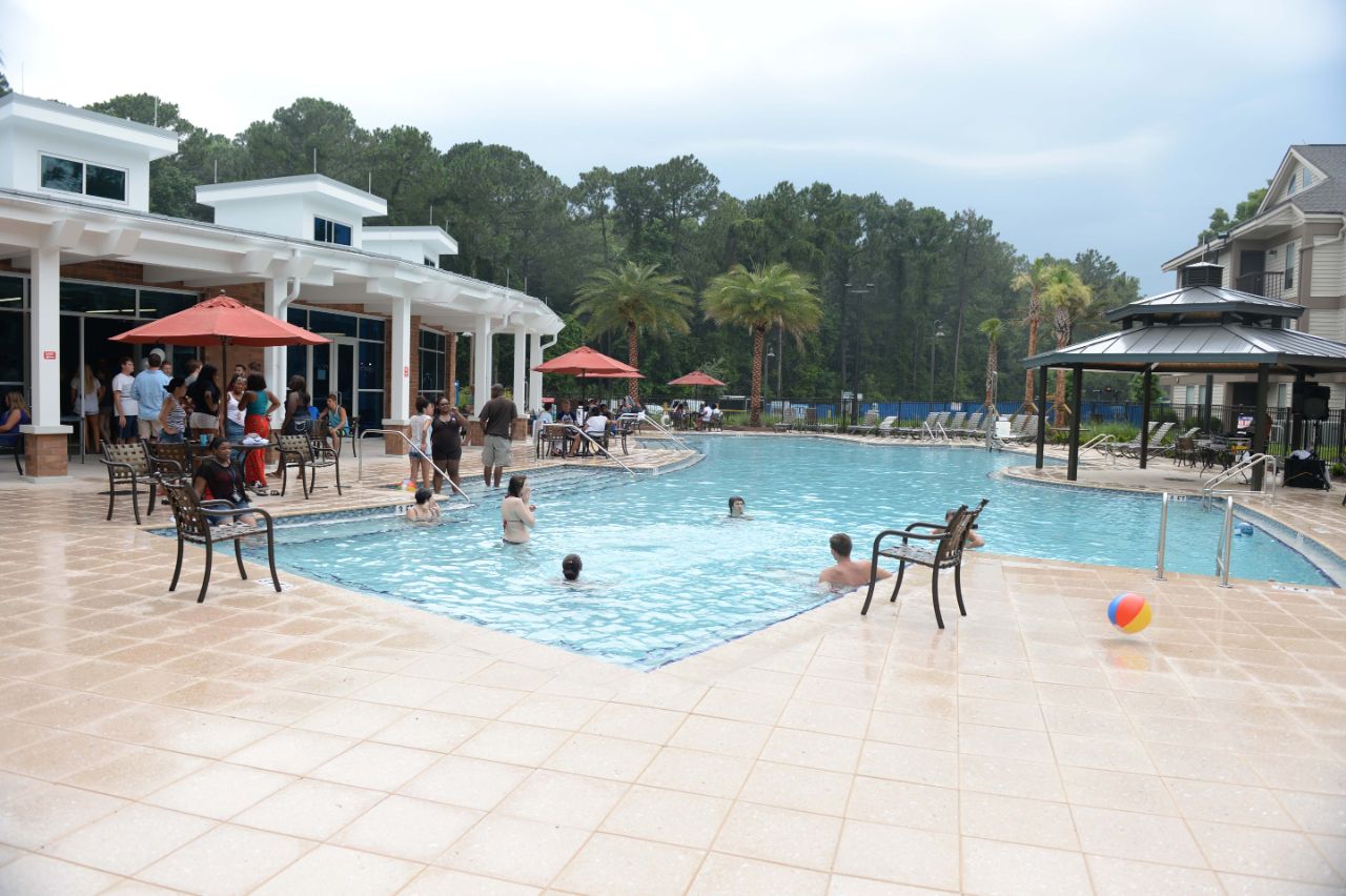 The Osprey Clubhouse pool with students swimming in the pool.