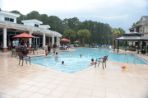 The Osprey Clubhouse pool with students swimming in the pool.