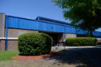 A brick building with a blue roof.